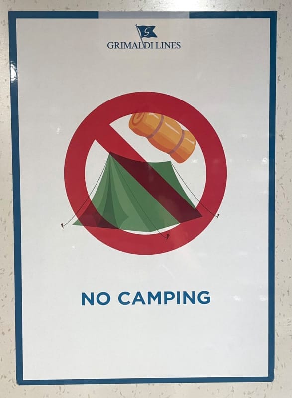 “No Camping” sign – indicating that camping on board of a ship is prohibited.