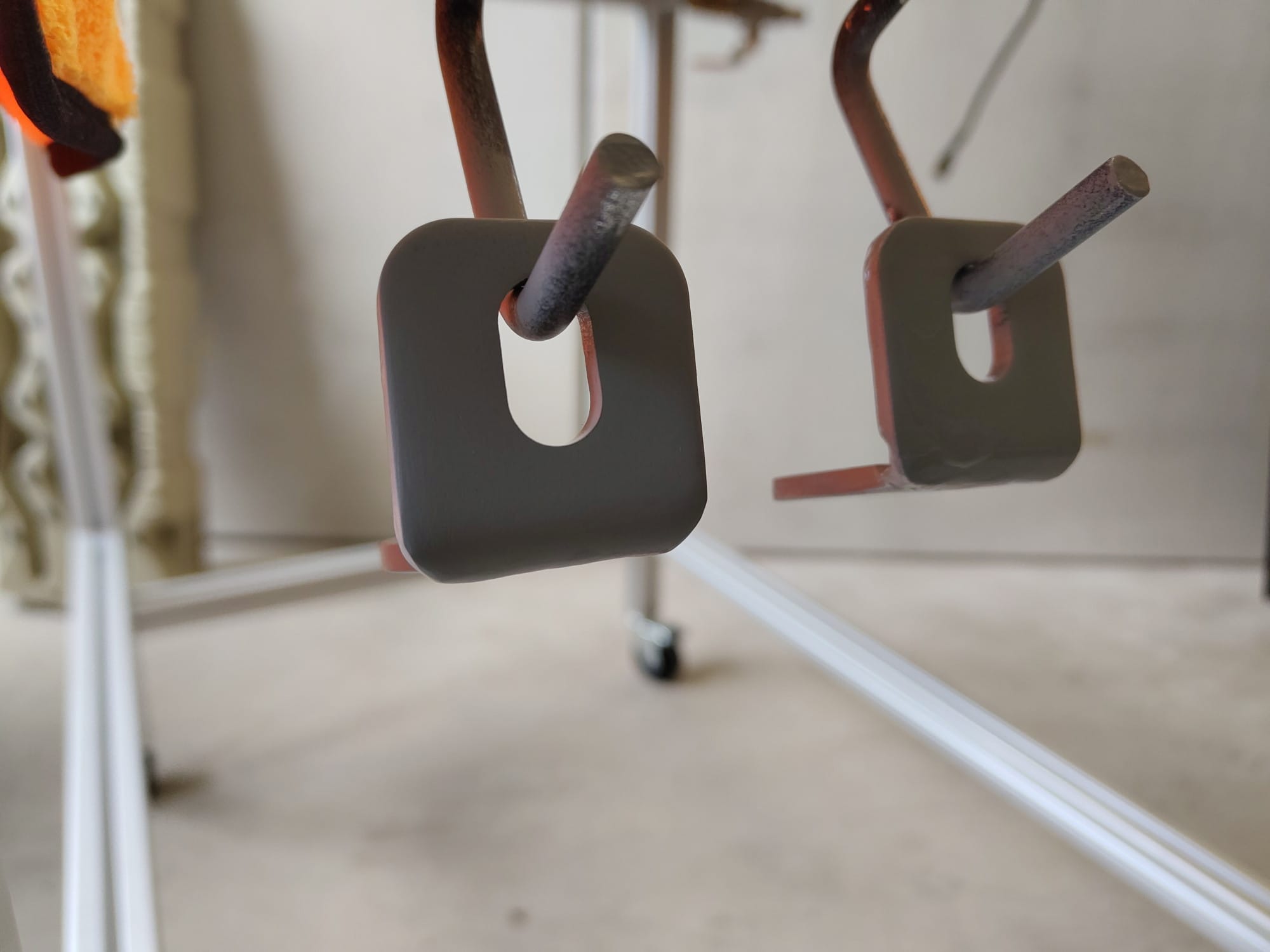 Brackets that hang from hooks so they can be spray-painted with primer