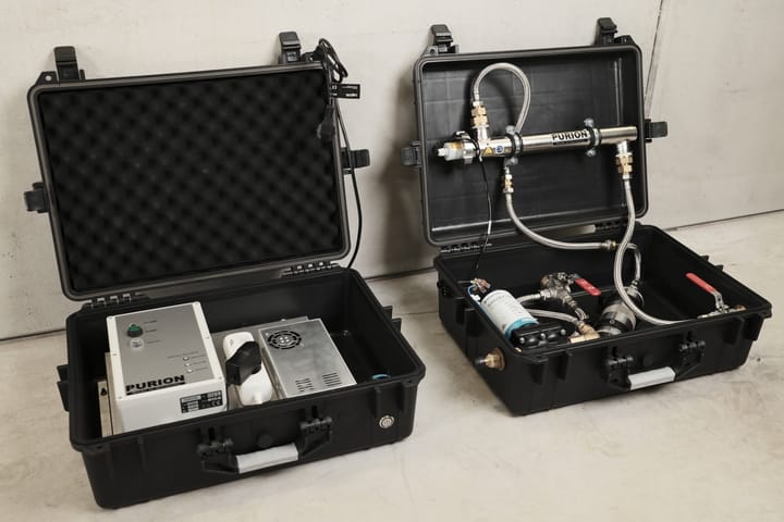Two outdoor cases containing electronics and a water filtration system